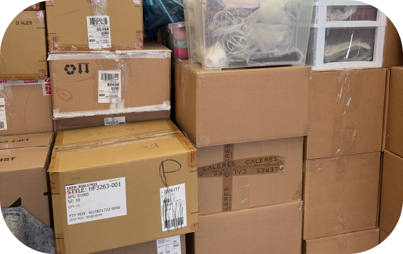 Tightly stacked moving boxes, plastic bins, and wrapped items ready for transport inside a truck